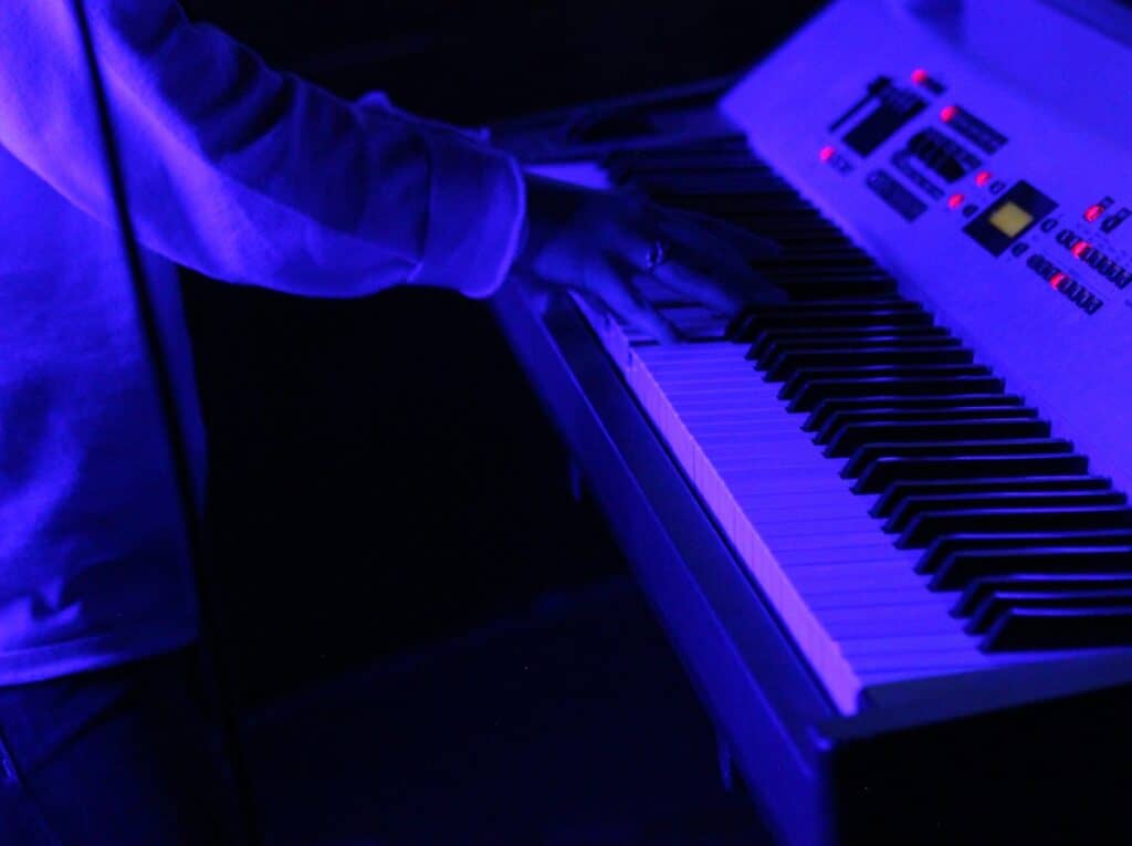 person playing digital piano keyboard
