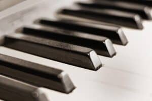 Closeup piano keys at an angle. This illustrates the beginner starting the exploration of finding the best piano.